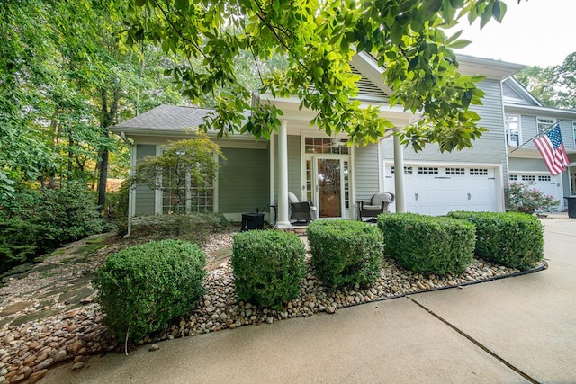 view of front of property with a porch and a garage