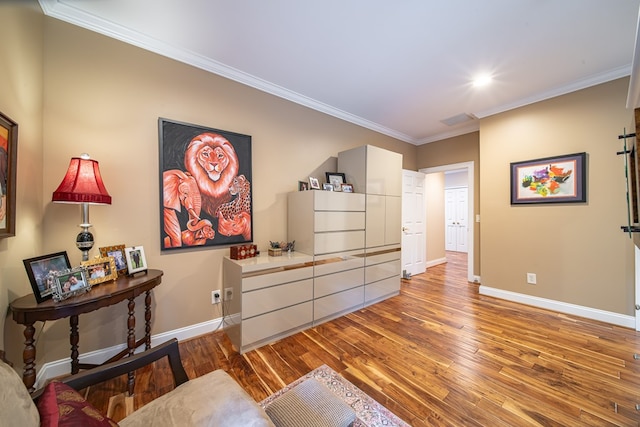 living area featuring hardwood / wood-style floors and ornamental molding