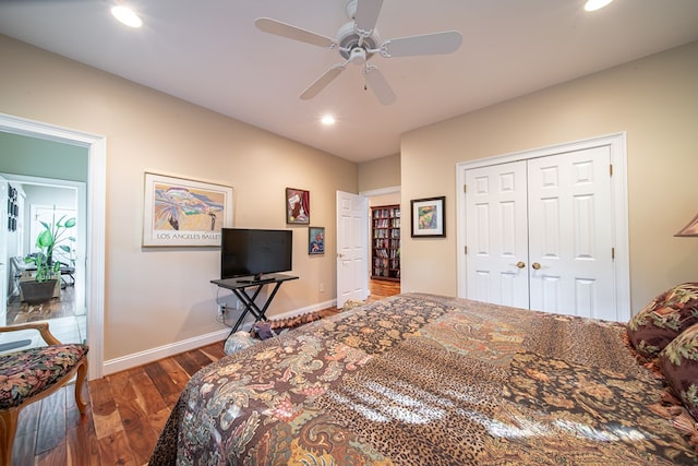 bedroom with dark wood-type flooring, a closet, and ceiling fan