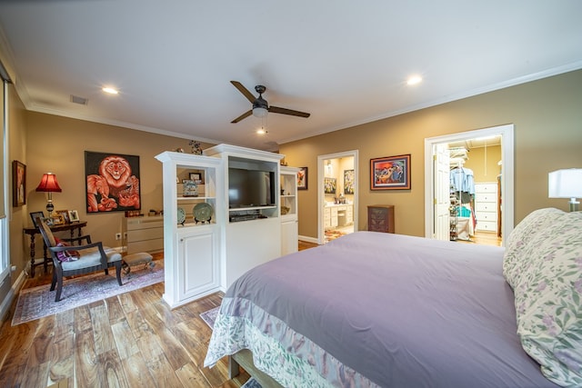 bedroom with crown molding, ceiling fan, connected bathroom, and light hardwood / wood-style floors