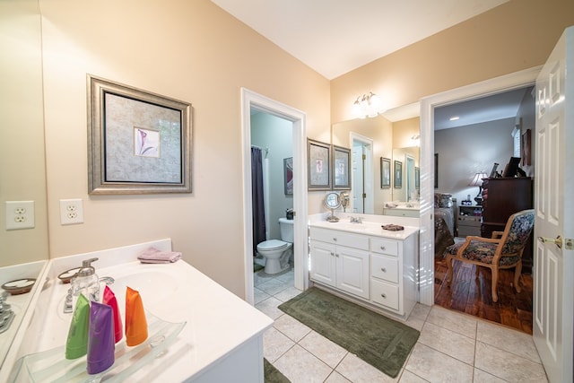 bathroom featuring tile patterned floors, toilet, and vanity