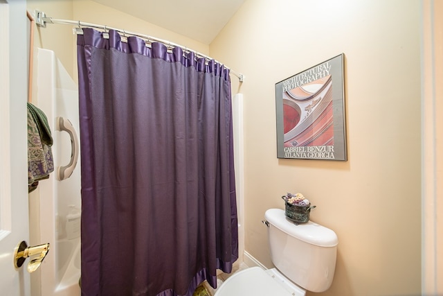 bathroom with shower / bath combo and toilet