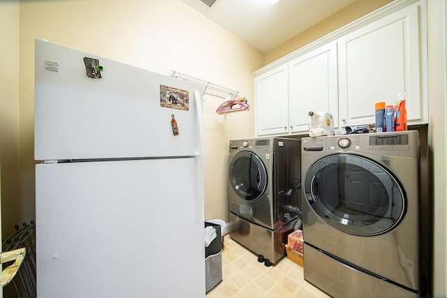 washroom featuring cabinets and washer and dryer