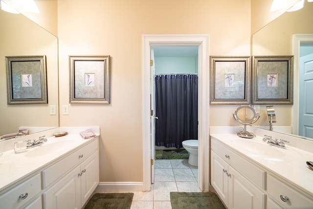 bathroom with tile patterned flooring, vanity, and toilet