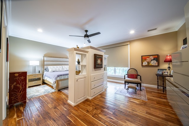 bedroom with ornamental molding, hardwood / wood-style floors, and ceiling fan