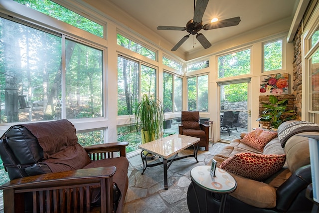 sunroom featuring ceiling fan and a healthy amount of sunlight