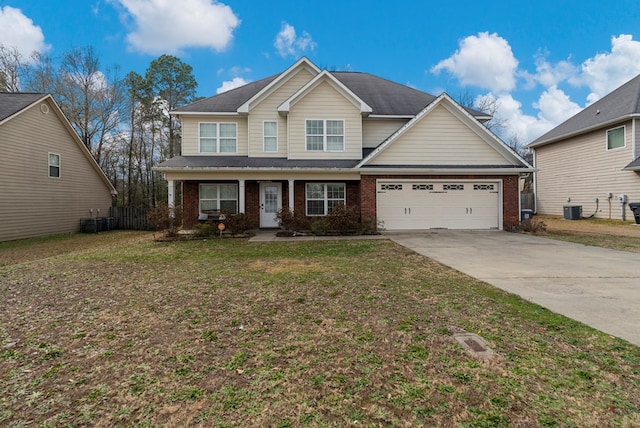 view of front of property featuring cooling unit, a garage, and a front yard