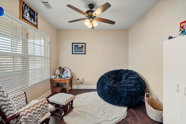 sitting room featuring ceiling fan and dark hardwood / wood-style flooring