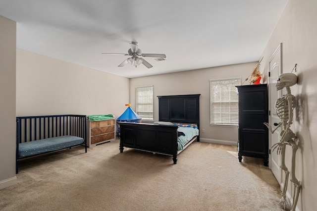 carpeted bedroom with multiple windows and ceiling fan