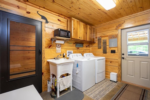 153 N Whatley Rd, Lagrange, GA 30240 - laundry area with washer and clothes dryer, cabinet space, wooden walls, and wood ceiling