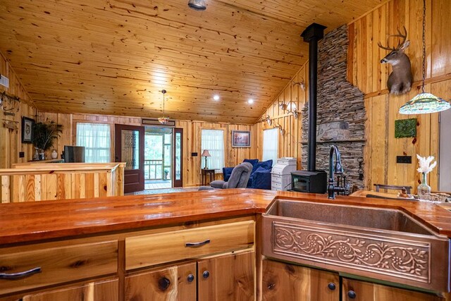 153 N Whatley Rd, Lagrange, GA 30240 - kitchen featuring butcher block countertops, a wood stove, wood ceiling, lofted ceiling, and a sink