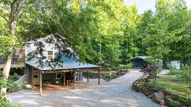 153 N Whatley Rd, Lagrange, GA 30240 - view of front facade with a detached carport, driveway, a patio, and metal roof