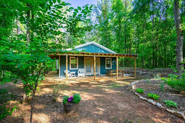 153 N Whatley Rd, Lagrange, GA 30240 - view of front of property featuring covered porch, a forest view, and board and batten siding