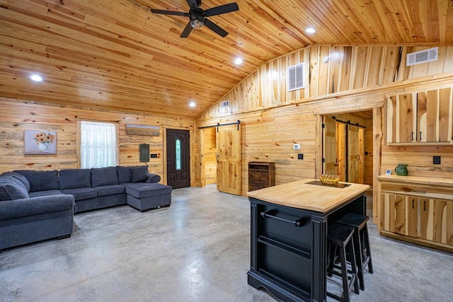 153 N Whatley Rd, Lagrange, GA 30240 - living area with a barn door, wood walls, wooden ceiling, a ceiling fan, and concrete floors