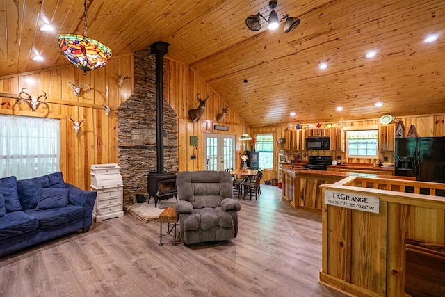 153 N Whatley Rd, Lagrange, GA 30240 - living area featuring a wood stove, wooden ceiling, plenty of natural light, light wood finished floors, and high vaulted ceiling
