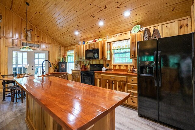 153 N Whatley Rd, Lagrange, GA 30240 - kitchen featuring black appliances, butcher block countertops, lofted ceiling, light wood-style flooring, and wood walls