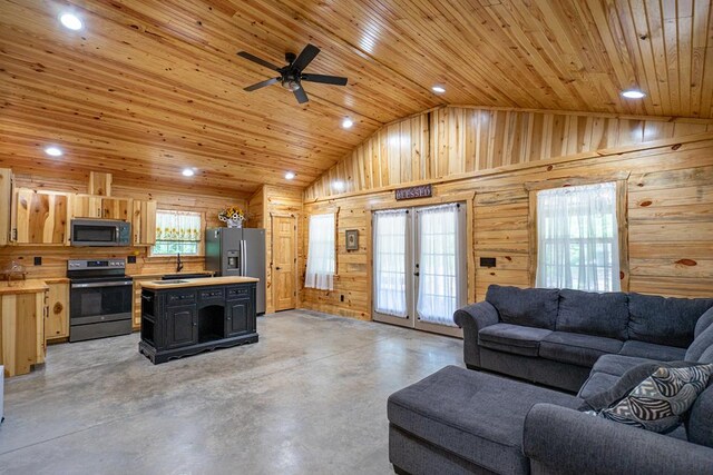 153 N Whatley Rd, Lagrange, GA 30240 - living area featuring concrete flooring, vaulted ceiling, wooden ceiling, wood walls, and a ceiling fan