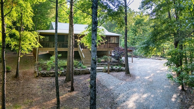 153 N Whatley Rd, Lagrange, GA 30240 - view of front facade featuring a sunroom, stairway, a wooded view, and metal roof