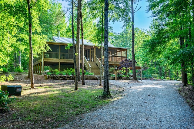 153 N Whatley Rd, Lagrange, GA 30240 - view of front facade featuring a sunroom, driveway, stairs, and metal roof