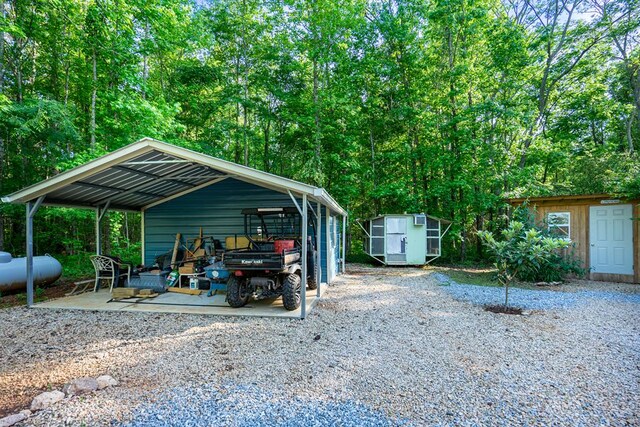 153 N Whatley Rd, Lagrange, GA 30240 - view of parking / parking lot with a storage unit, a carport, and gravel driveway