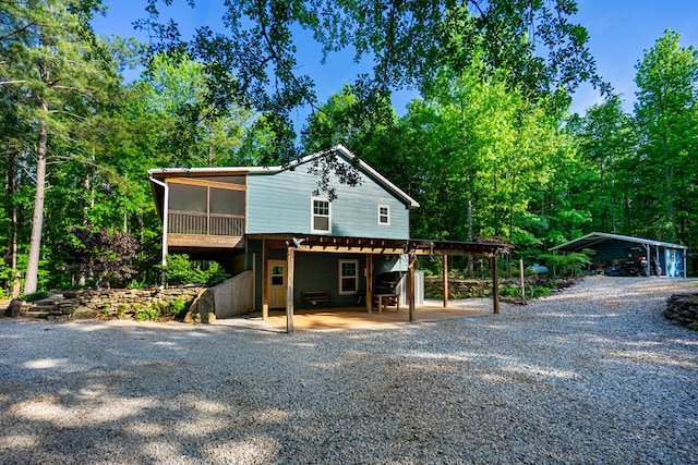 153 N Whatley Rd, Lagrange, GA 30240 - view of front of house featuring a sunroom, driveway, a carport, and a patio area