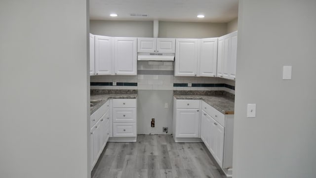 2830 N Lumpkin Rd, Columbus, GA 31903 - kitchen featuring decorative backsplash, white cabinets, light wood finished floors, dark countertops, and recessed lighting