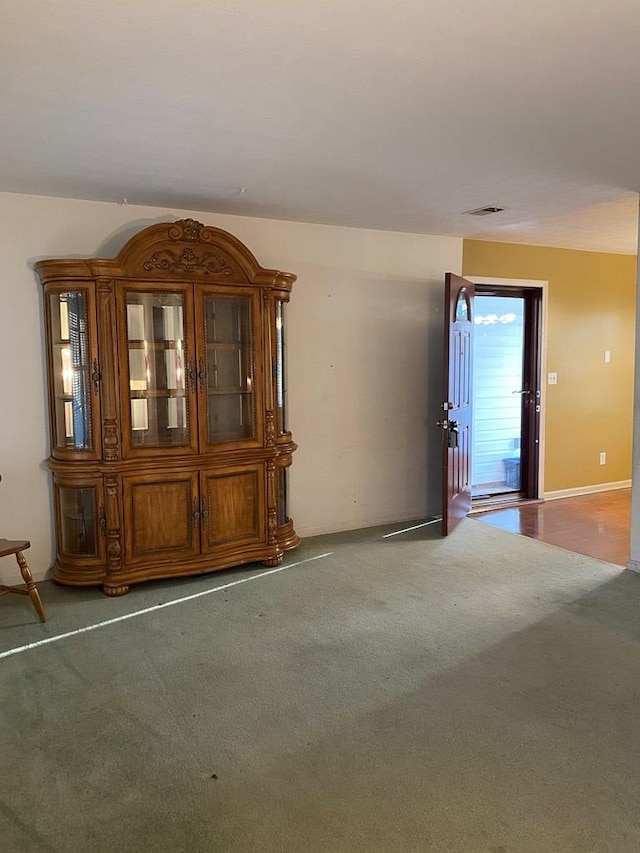 empty room with visible vents and carpet flooring