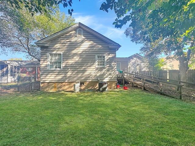 view of property exterior featuring a yard and central AC