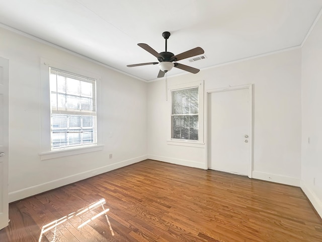 unfurnished room featuring hardwood / wood-style floors, ceiling fan, and crown molding