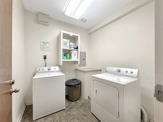 washroom with separate washer and dryer and electric panel