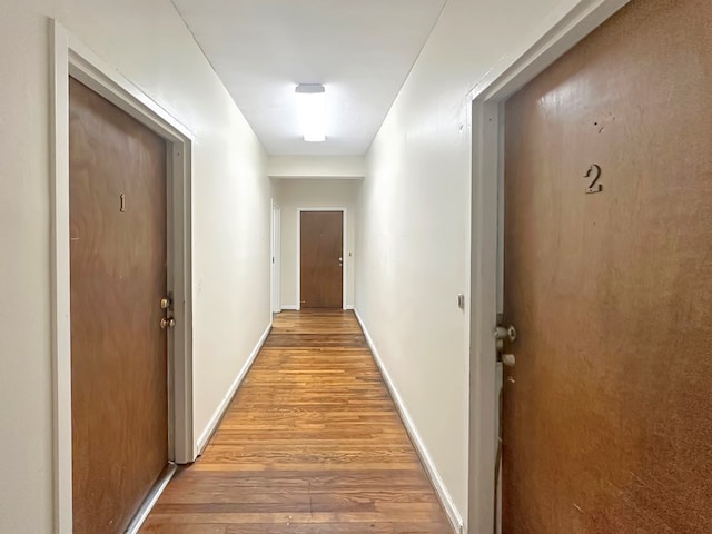 corridor with light hardwood / wood-style floors