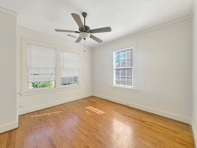 spare room featuring ceiling fan, wood-type flooring, and ornamental molding