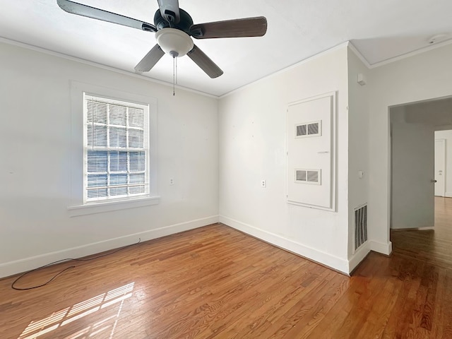 spare room featuring hardwood / wood-style flooring, ceiling fan, and ornamental molding