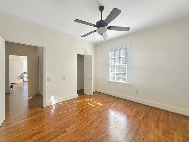 unfurnished bedroom with hardwood / wood-style floors, ceiling fan, and crown molding