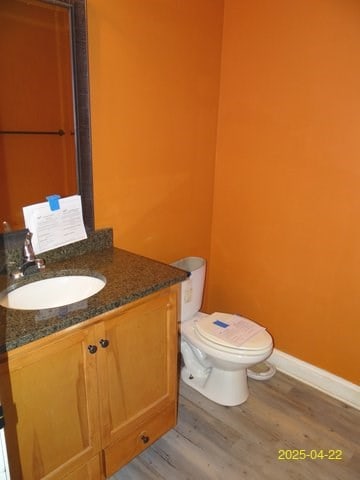 1111 Richland Dr, Columbus, GA 31907 - bathroom with toilet, vanity, wood finished floors, and baseboards