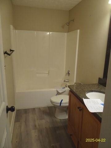 1111 Richland Dr, Columbus, GA 31907 - bathroom with wood finished floors, toilet, vanity, and shower / tub combination