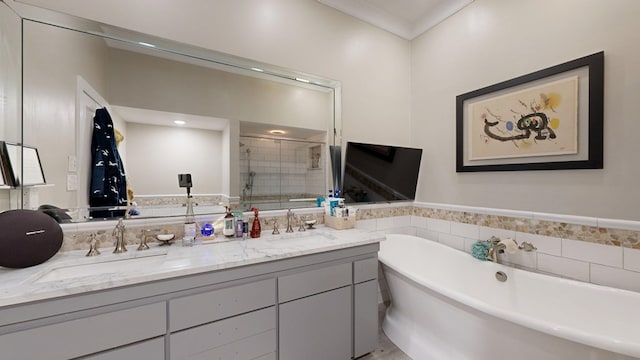 full bath with double vanity, a sink, a freestanding bath, and a shower stall