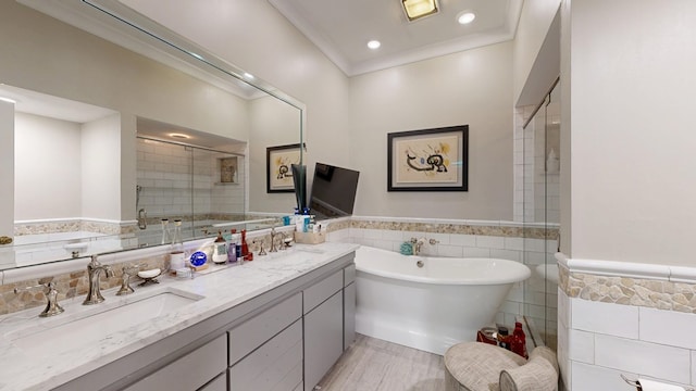 full bathroom featuring a freestanding tub, tile walls, a shower stall, and double vanity