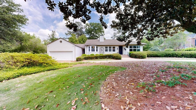 ranch-style home featuring a garage, a front lawn, and a chimney