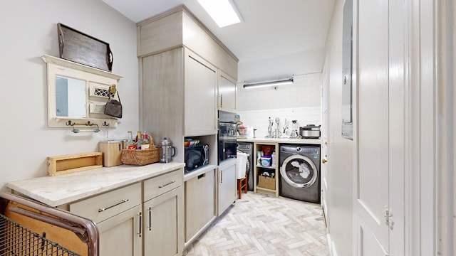 kitchen with backsplash, washer / dryer, light stone counters, and black microwave
