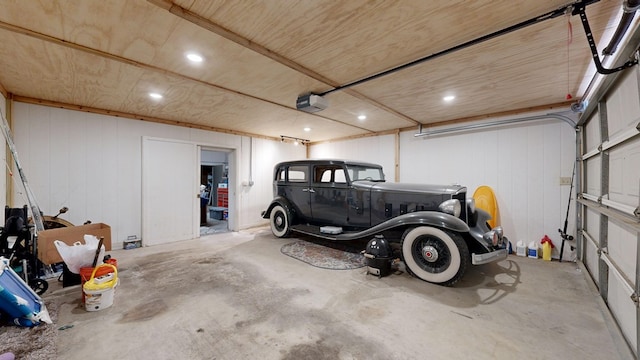 garage with a garage door opener and recessed lighting