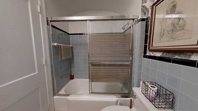bathroom with enclosed tub / shower combo and toilet