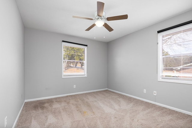 empty room featuring light carpet and ceiling fan