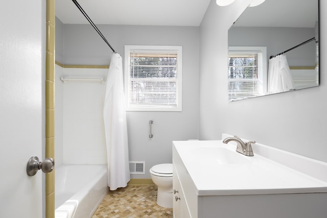 full bathroom featuring vanity, shower / tub combo, and toilet