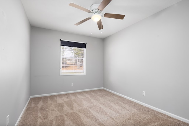 carpeted spare room with ceiling fan