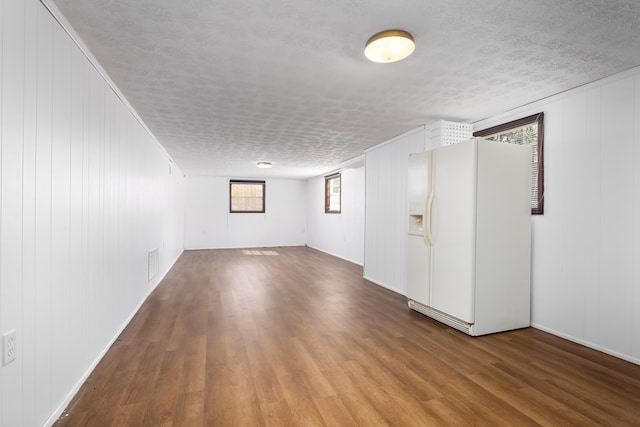 spare room featuring hardwood / wood-style floors and a textured ceiling