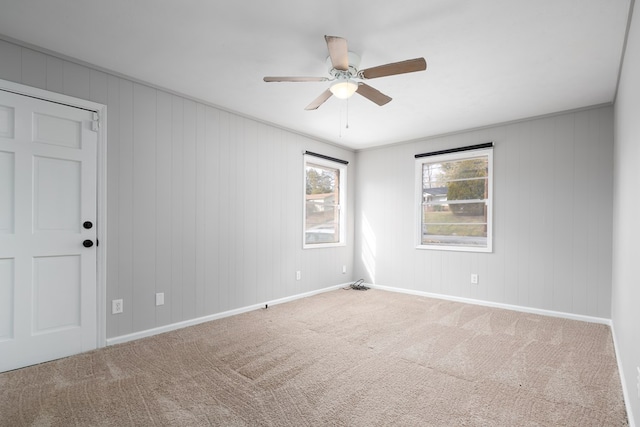 empty room featuring ceiling fan and carpet flooring