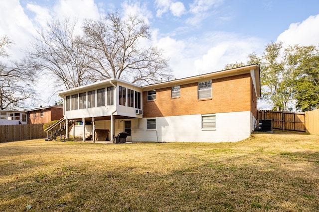 back of property featuring a yard, central AC, and a sunroom