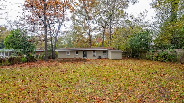 rear view of property with a yard