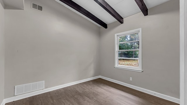 empty room featuring hardwood / wood-style flooring and vaulted ceiling with beams